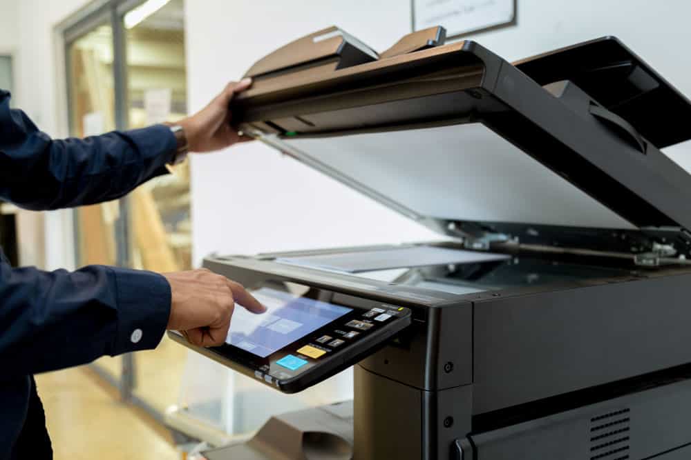 A man using a printer in an office