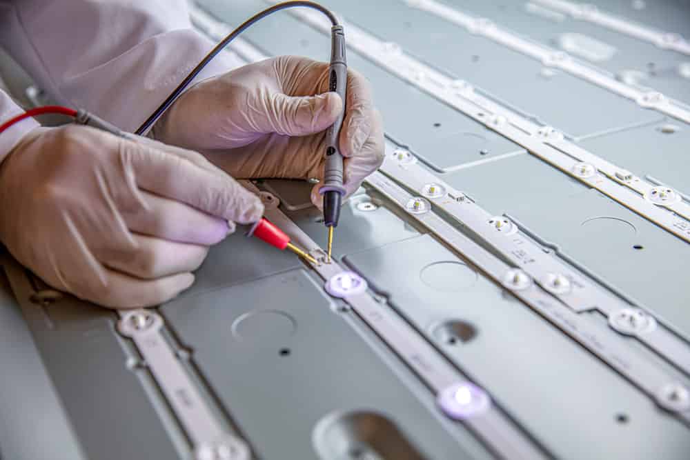 An engineer testing a LED board voltage