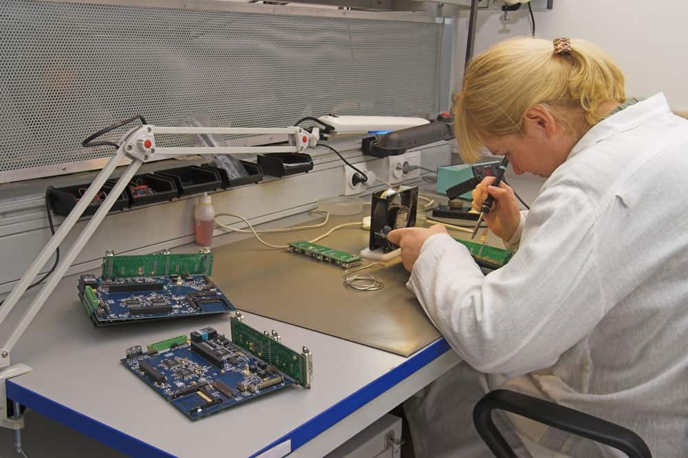 Flexible PCB Coverlay:  An engineer handling circuit boards