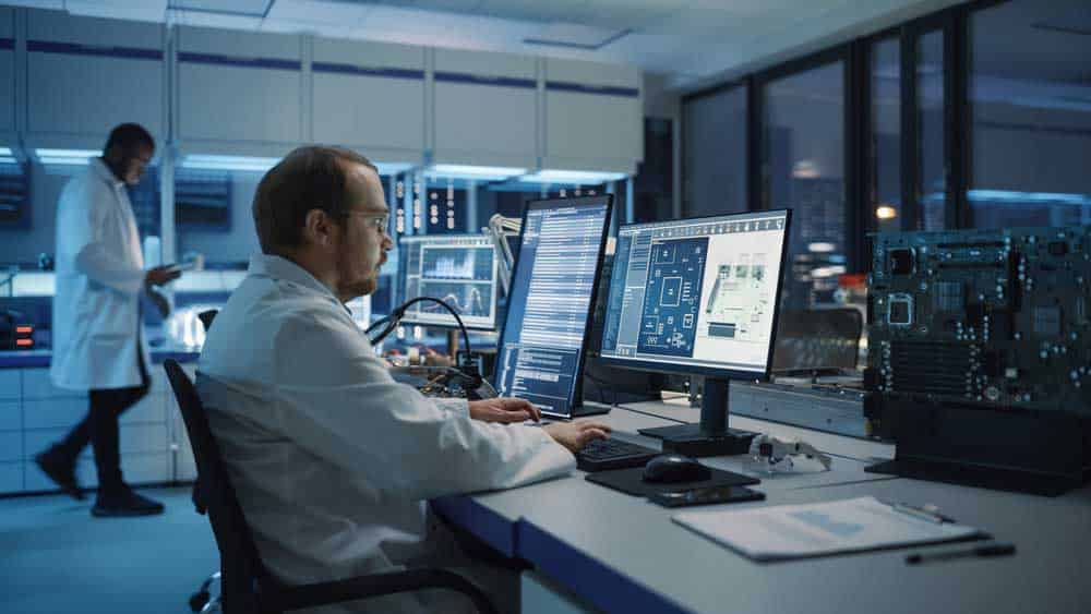 A scientist engineer in a modern electronic facility using design software