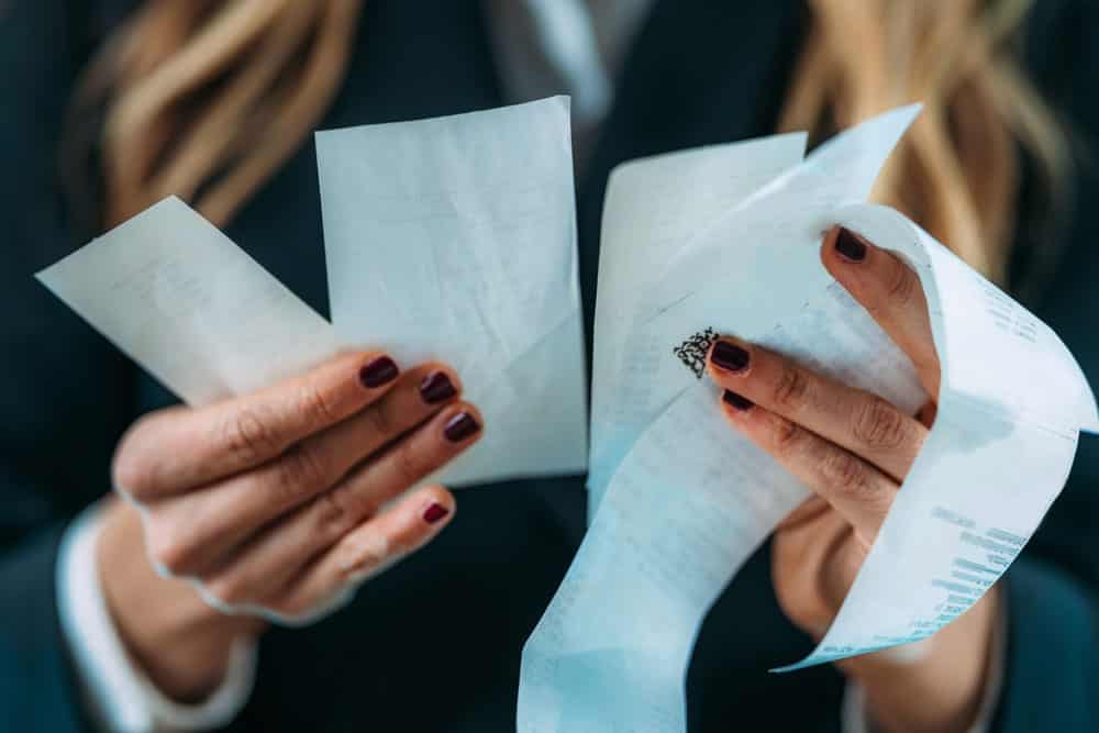 A woman going through purchase receipts